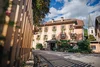 Hospitality building with flower-adorned windows in a mountain village on a sunny day