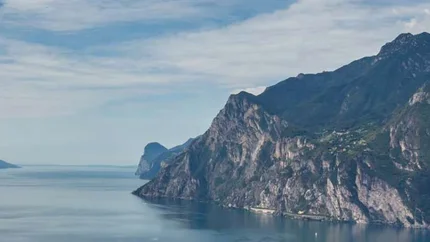 View of a fjord with steep mountains and a cloudy sky