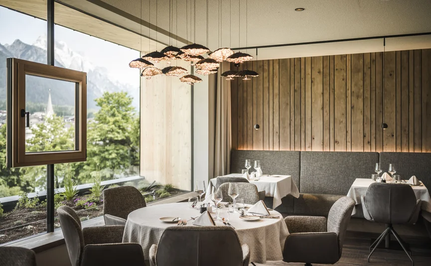 Elegant restaurant interior with mountain view and modern pendant lights