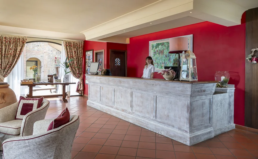 Hotel reception with a receptionist behind the counter
