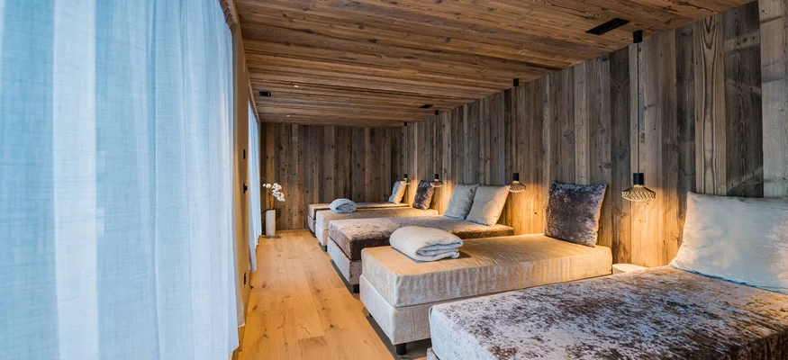 Relaxation room with heated loungers and wooden walls