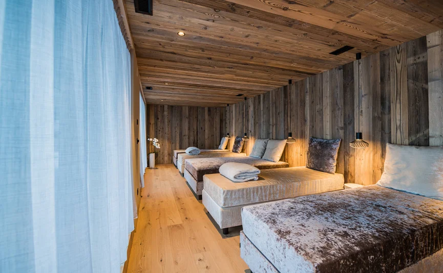 Relaxation room with heated loungers and wooden walls