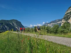 South Tyrol's south Cyclists riding on a path with mountains and blue sky in the background