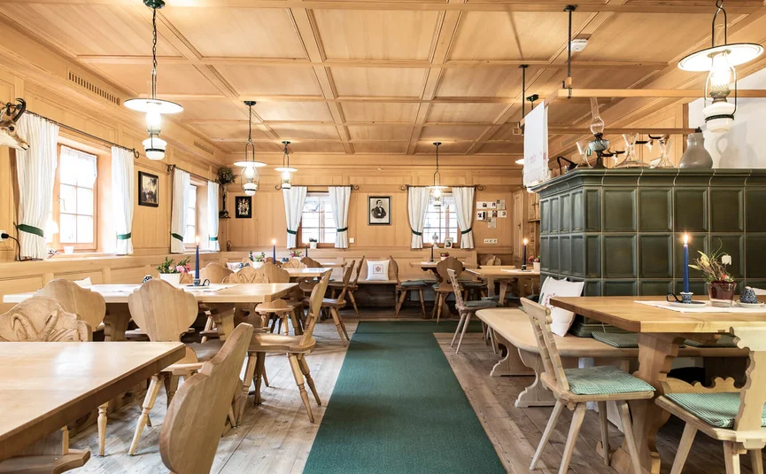 Cozy traditional dining room with wood paneling and wooden furniture
