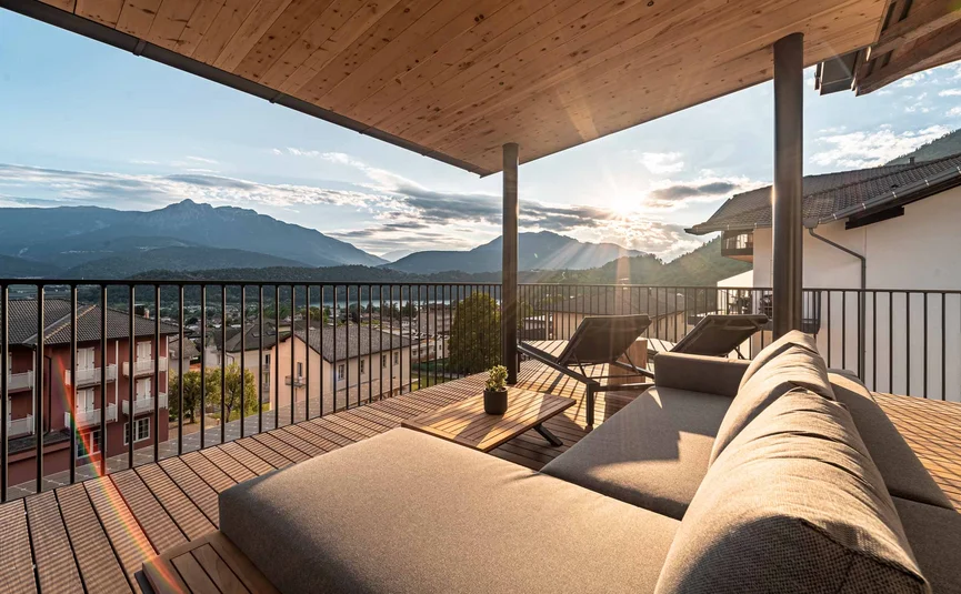 Cristallo Sport & Wellness Hotel **** © Andrea Acler Terrace with sofa and loungers overlooking mountains at sunset