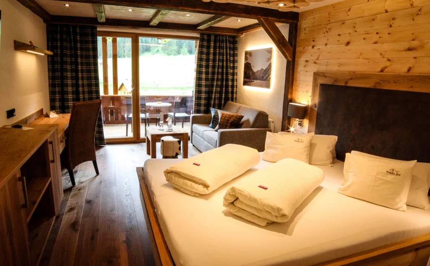 Cozy hotel room with double bed and balcony with view