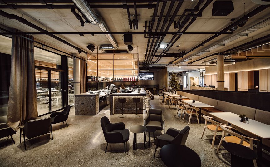 Modern café with stylish seating and industrial design bar area