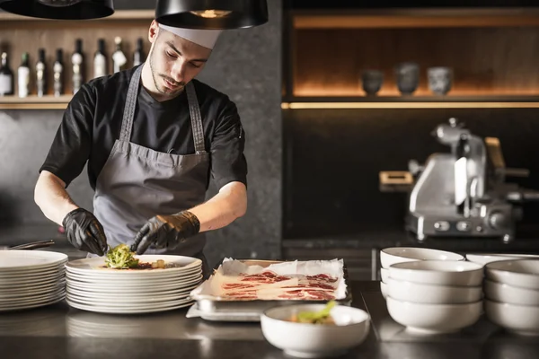 Gravel bike hotels © Hannes Niederkofler Chef preparing dishes in a professional kitchen