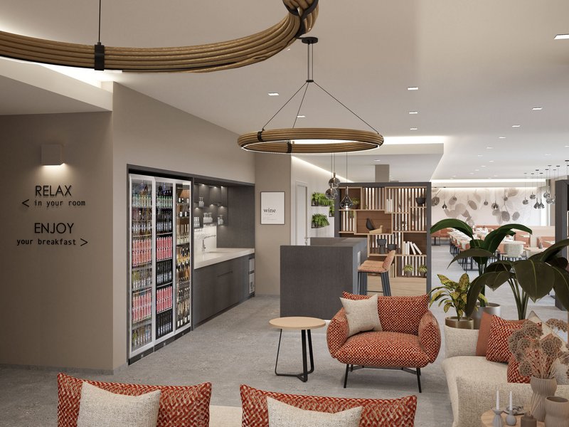 Gravelbike Holidays © Garni Hotel Cornelian Modernes Hotel-Lounge mit Sitzbereich, Snackbar und Esstisch