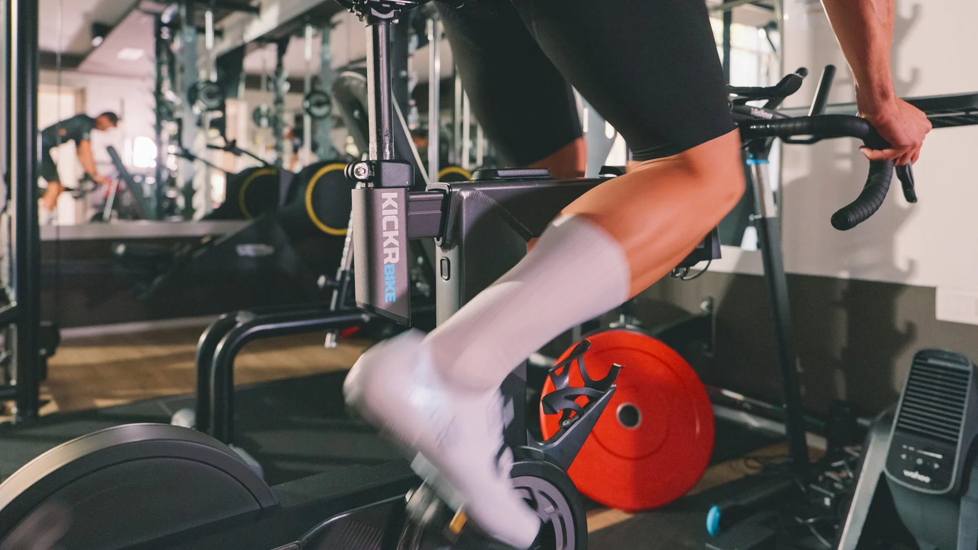 Person trainiert auf einem KICKR Smart Bike im Fitnessstudio