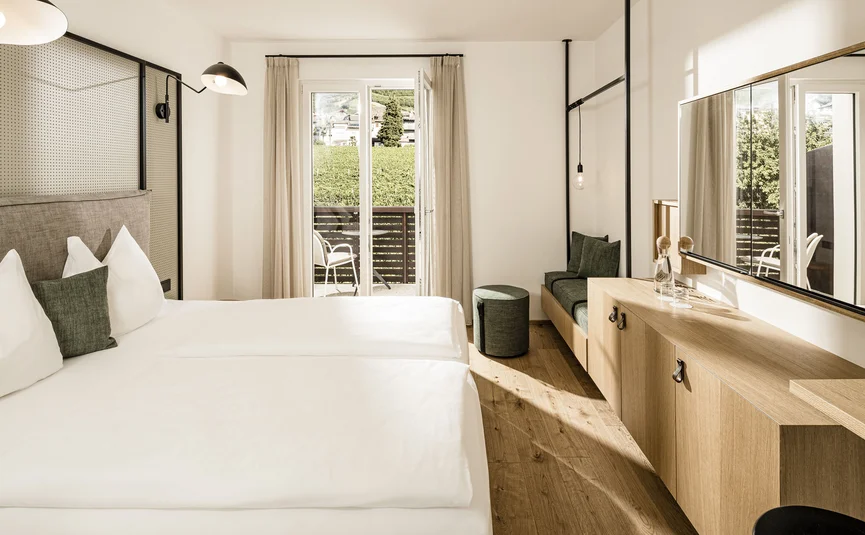 Modern hotel room with balcony and nature view