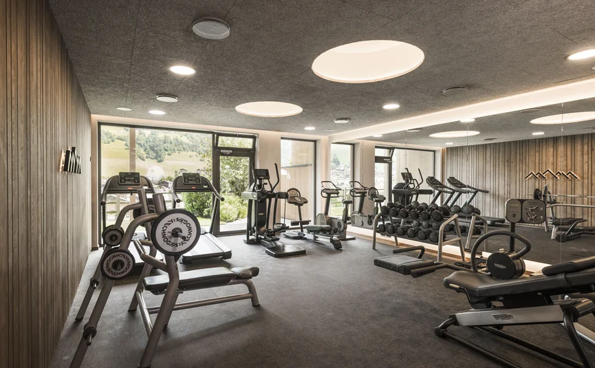 Modern gym with dumbbells and treadmills in a bright room