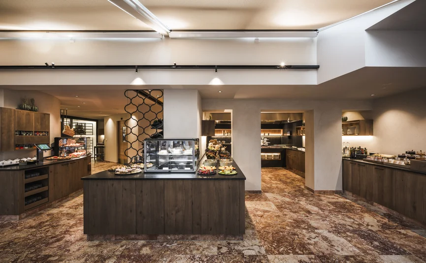 Modern buffet with desserts and food in a bright room