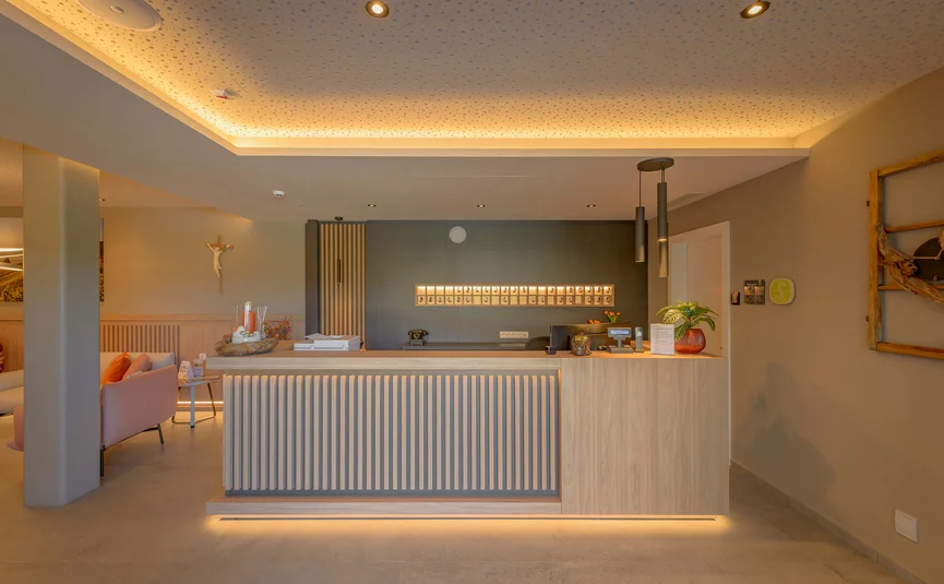 Modern reception area with illuminated counter and warm lighting
