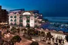 Lungomare beach hotel lit up at night with sea view