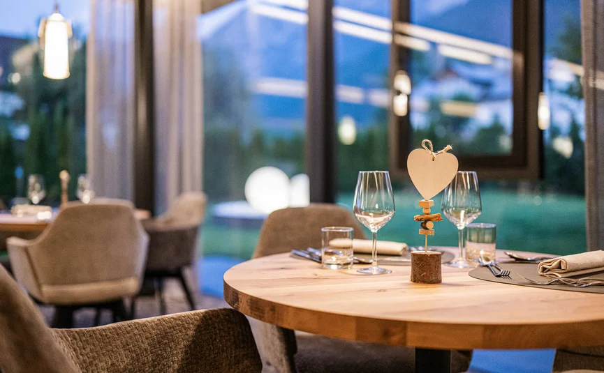 Elegantly set table with heart decoration in modern restaurant