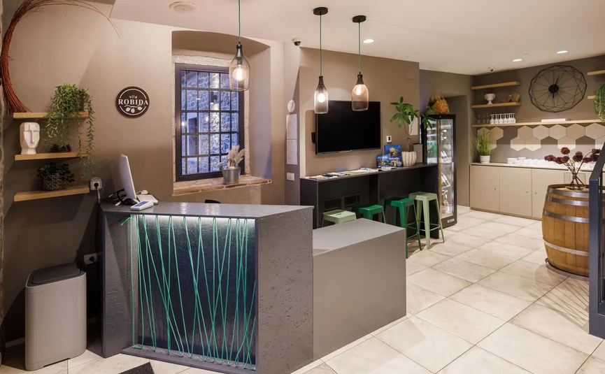 Reception area with desk and seating in a modern hotel interior
