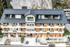 Exterior of Rossli Hotel with terrace and mountain backdrop