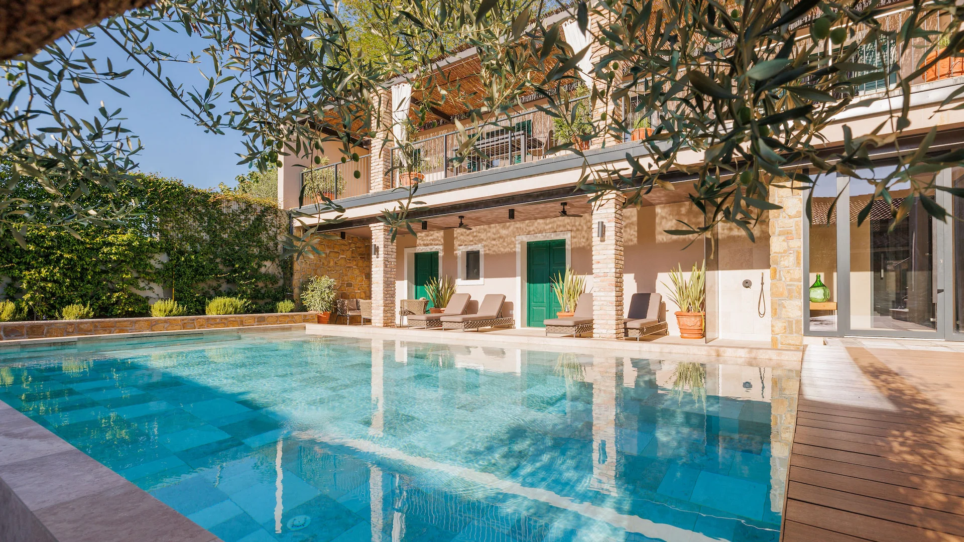 House with swimming pool and garden under blue sky