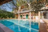 House with swimming pool and garden under blue sky