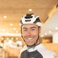 Daniele Acler © Daimp Gestioni Srl Smiling cyclist wearing helmet in a sport and wellness hotel setting