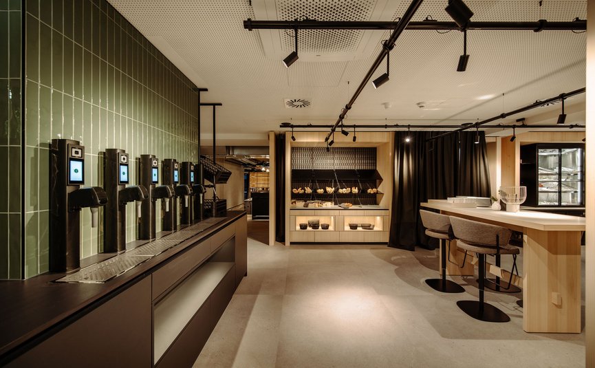 Modern snack bar with taps, seating area, and bread display