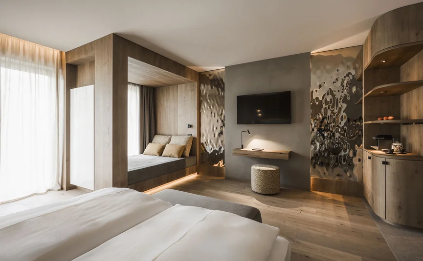 Modern hotel room with double bed and wooden accents