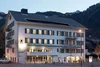 Hotel building with lit windows in evening mountain setting