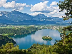 Lake with island and mountain landscape under clear sky