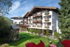Hotel building with balconies and playground in the garden