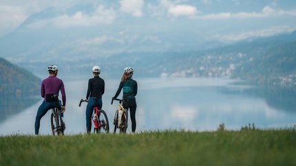 The centre of Carinthia © Martin Hofmann Three cyclists with helmets overlooking a lake and mountains