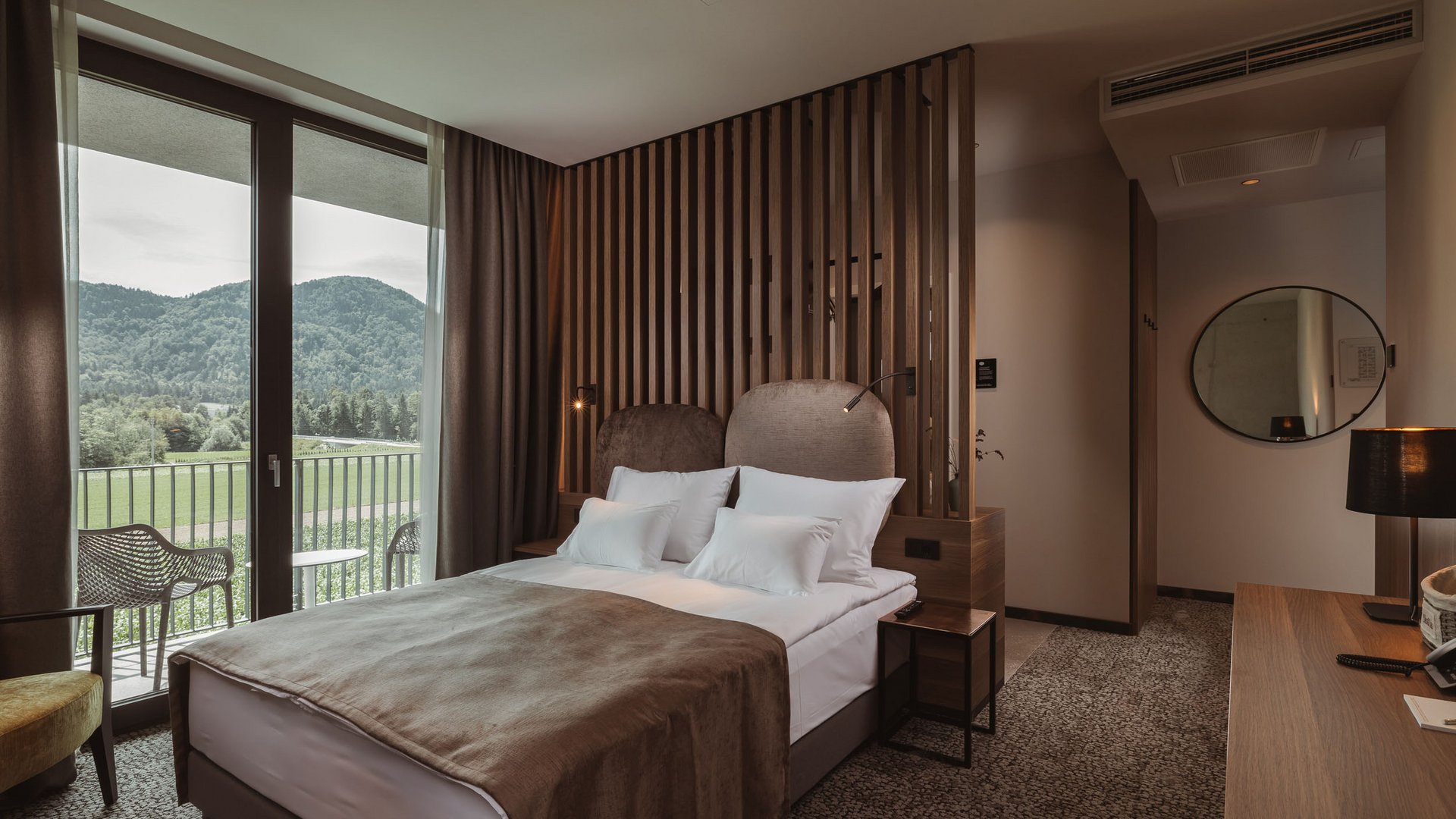 Gravelbiken im Savinja-Tal © Ziga Intihar Modernes Hotelzimmer mit Doppelbett und Balkon mit Bergblick