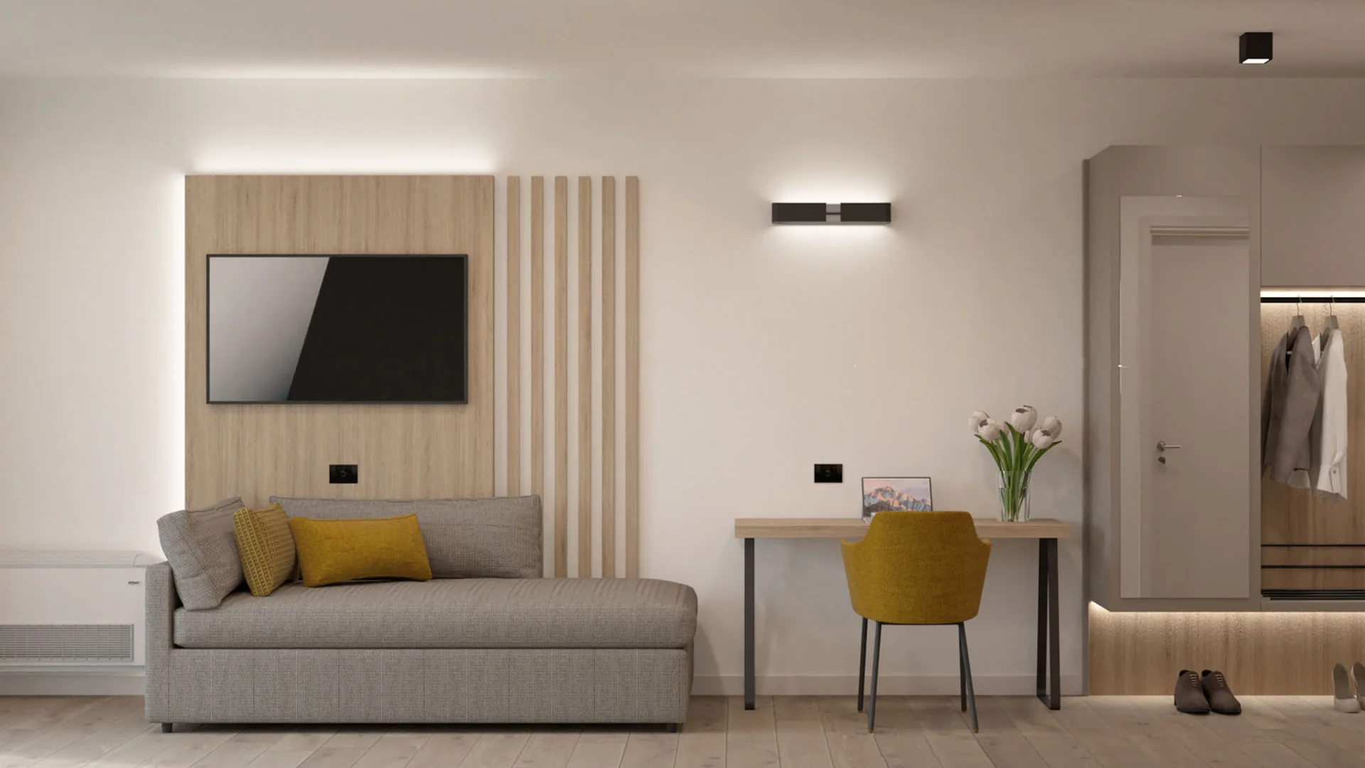 Moderner kleiner Wohnraum mit grauem Sofa, gelbem Stuhl und Garderobe