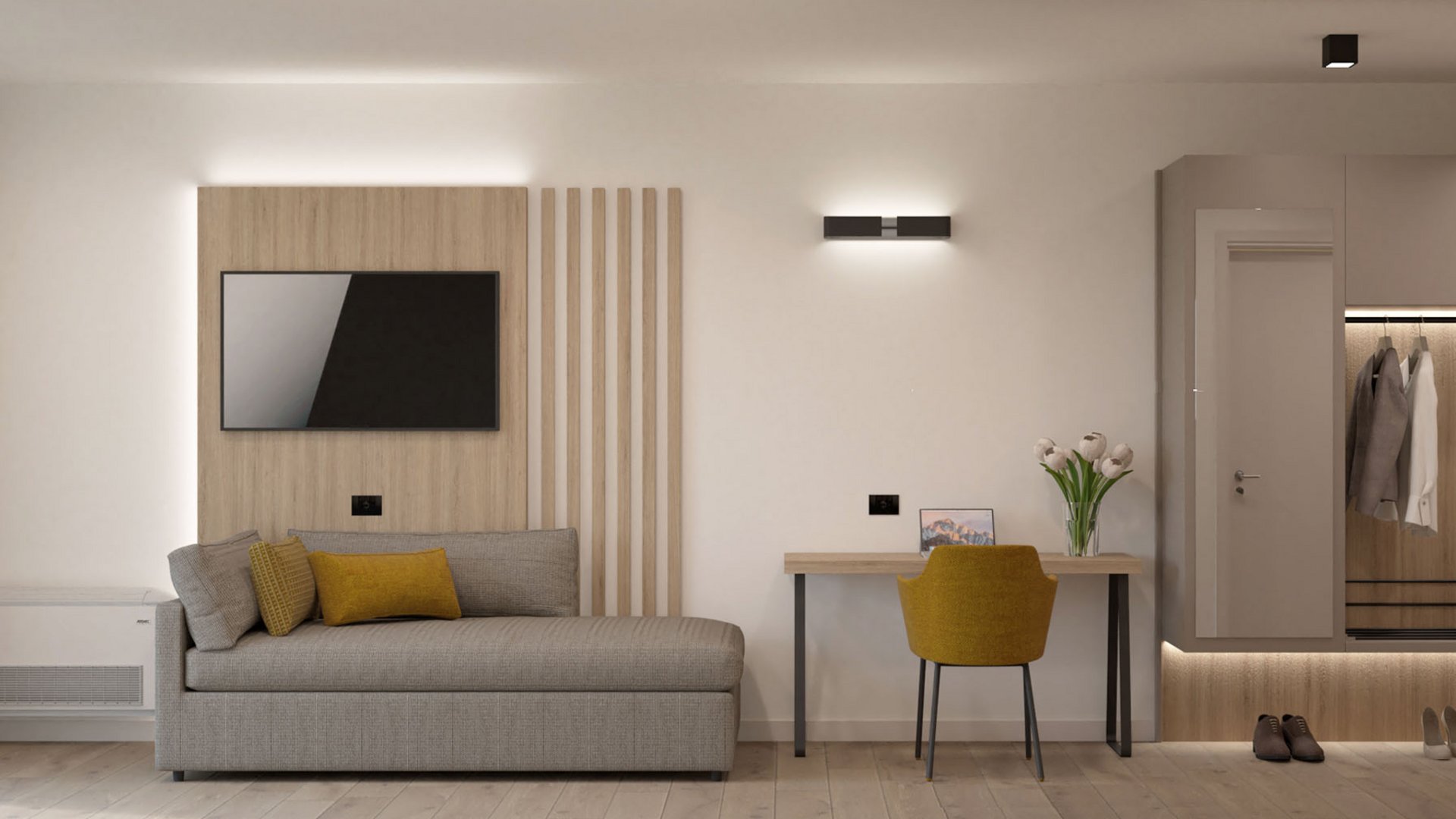 Moderner kleiner Wohnraum mit grauem Sofa, gelbem Stuhl und Garderobe