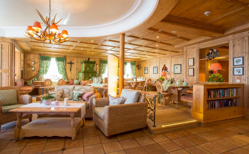 Cozy restaurant with wood paneling and antique green stove