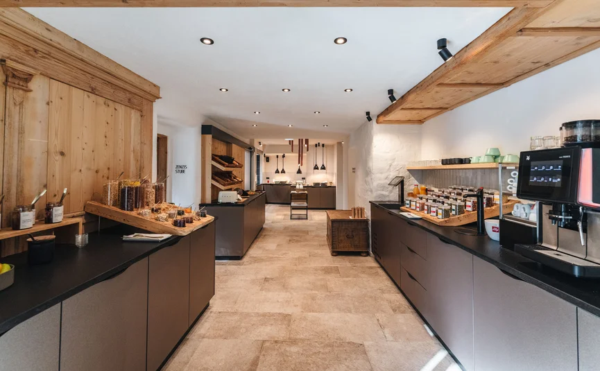 Modern kitchen with wood ceiling, coffee machine, and spice rack