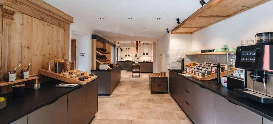 Modern kitchen with wood ceiling, coffee machine, and spice rack
