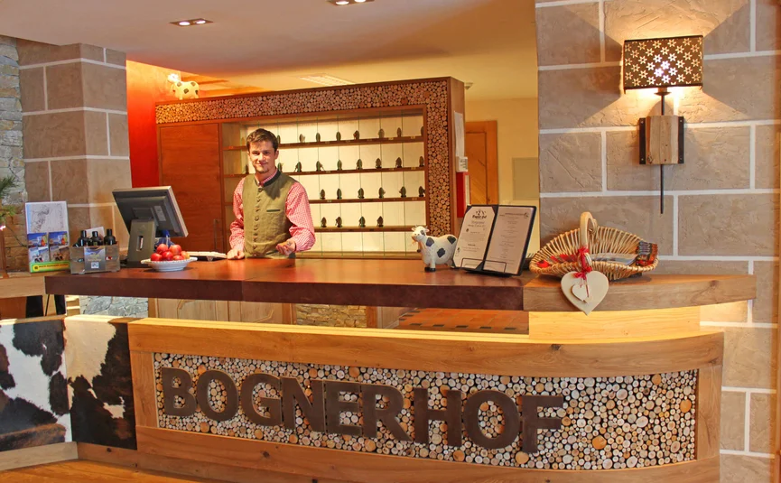 Reception with man in traditional attire at Hotel Bognerhof