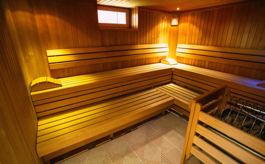 Leere Holzsauna mit Bank und Saunaofen