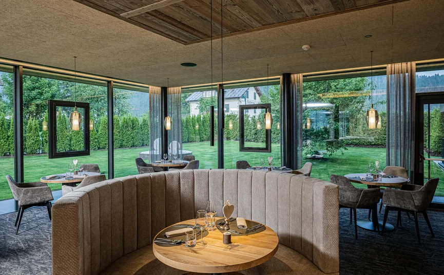 Modern restaurant with large windows and round tables