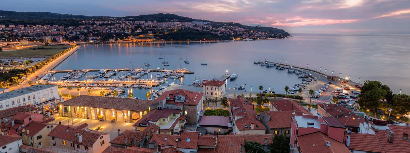 Vinska Fontana © www.slovenia.info - Jaka Ivancic Evening view of harbor and town with illuminated buildings by the water