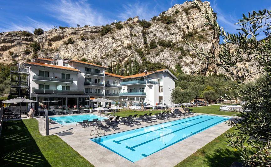 Hotel with two pools in front of cliffs and blue sky