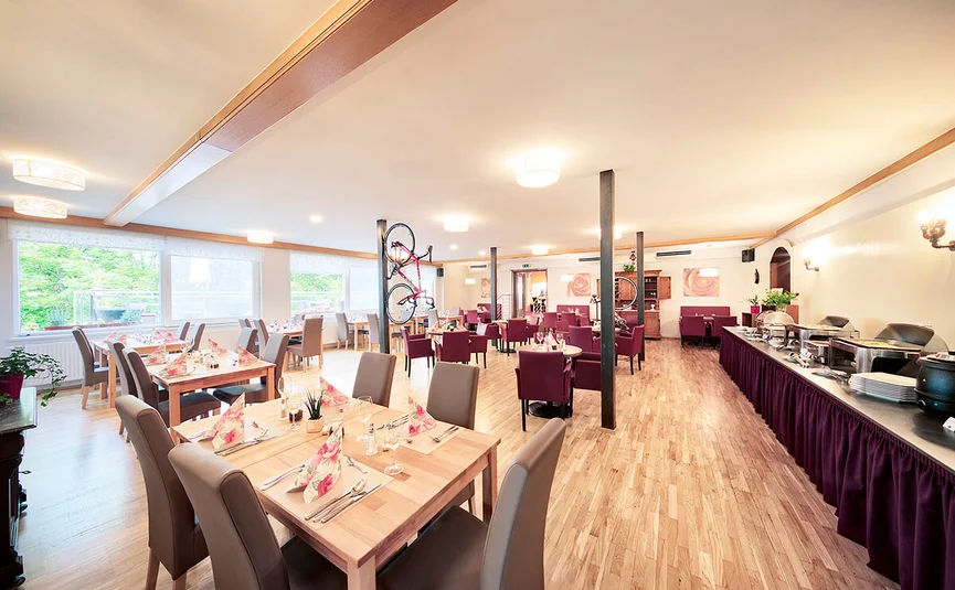 Bright spacious restaurant with set tables and buffet area