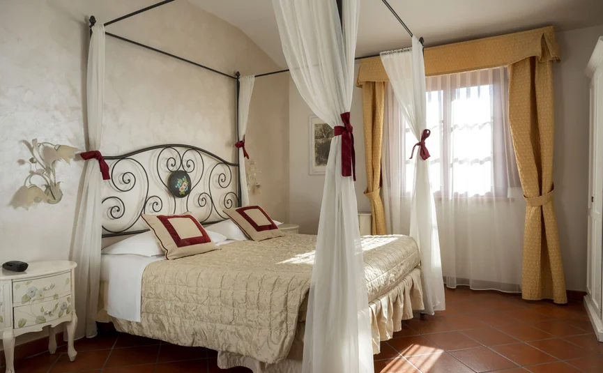 Elegant bedroom with canopy bed and warm tones