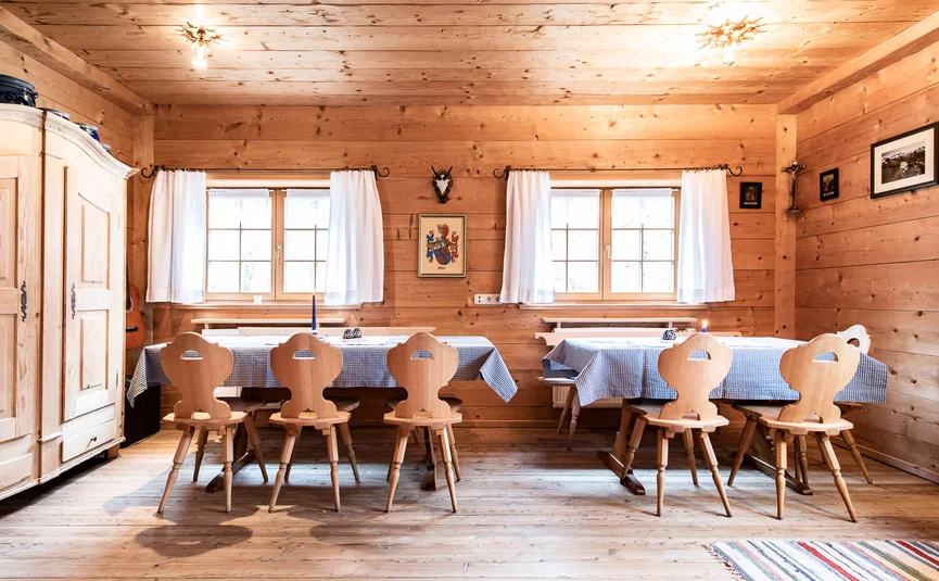 bright wooden dining room with tables and chairs in rustic style