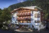 Beautiful mountain hotel with balconies decorated with flowers