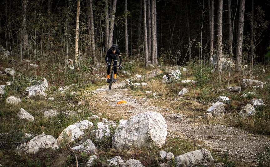 Gravel bike holiday on Northern Lake Garda © Gijs Ferkranus - Wielrenblad Magazine Cyclist rides on rough forest trail among rocks and trees