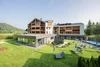 Modern hotel with garden, pool, and sun loungers in sunny setting