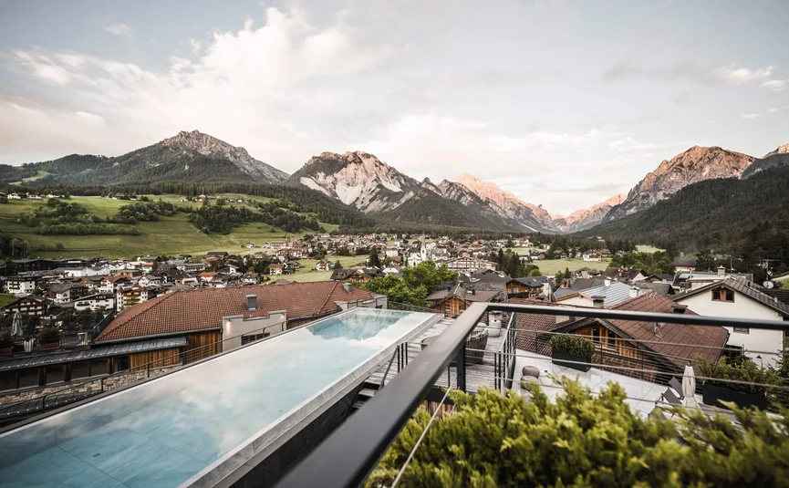 View of Alpine village with swimming pool in foreground